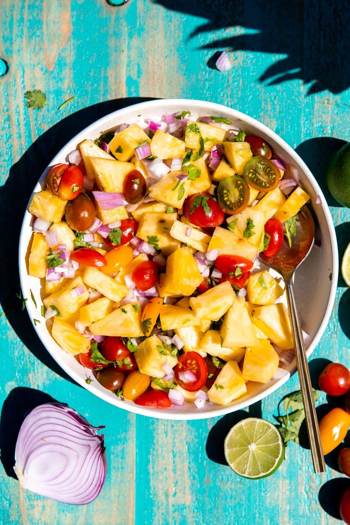 A bowl of pineapple salsa with all of the ingredients mixed together. 