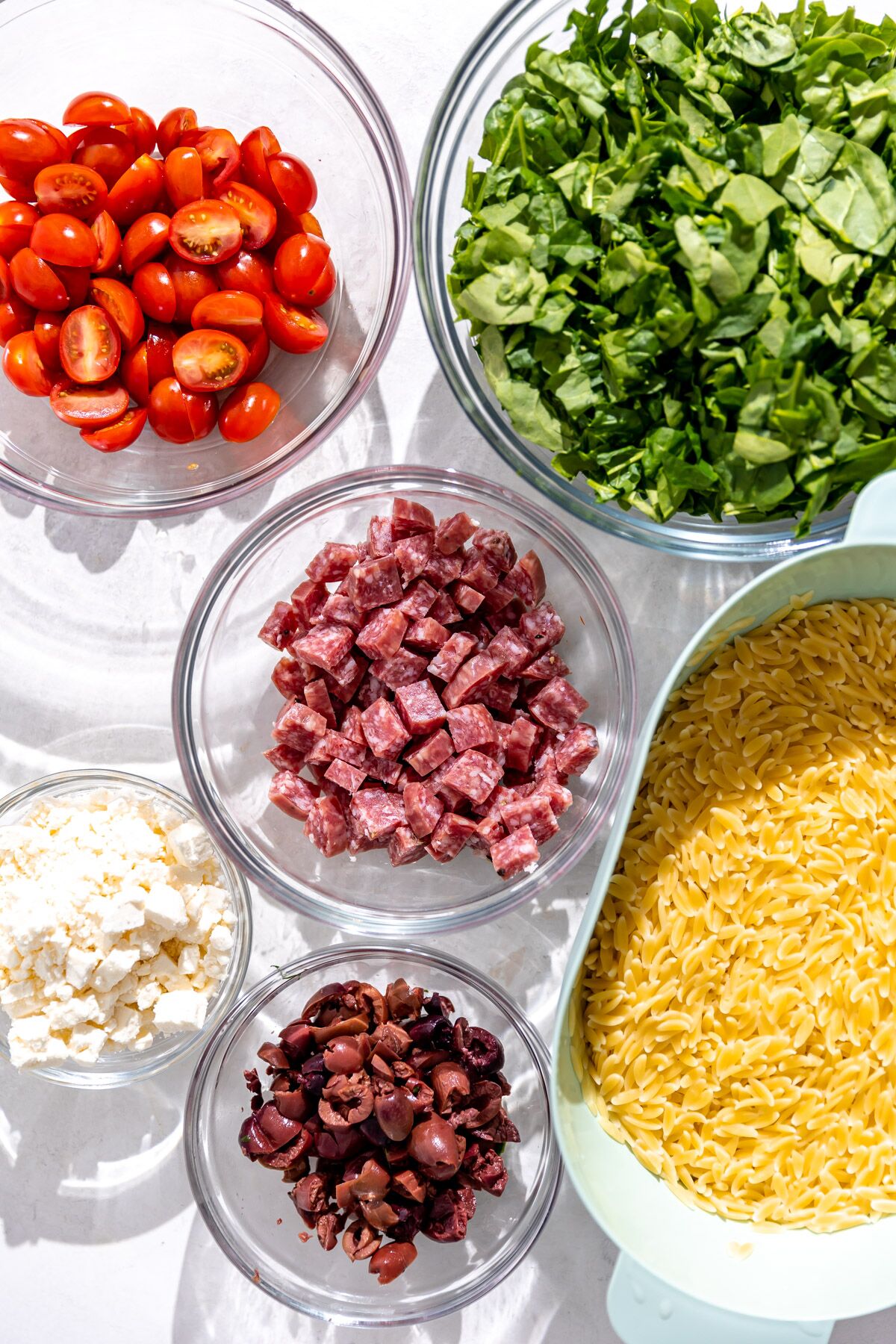 All of the ingredients needed for Mediterranean Pasta Salad.