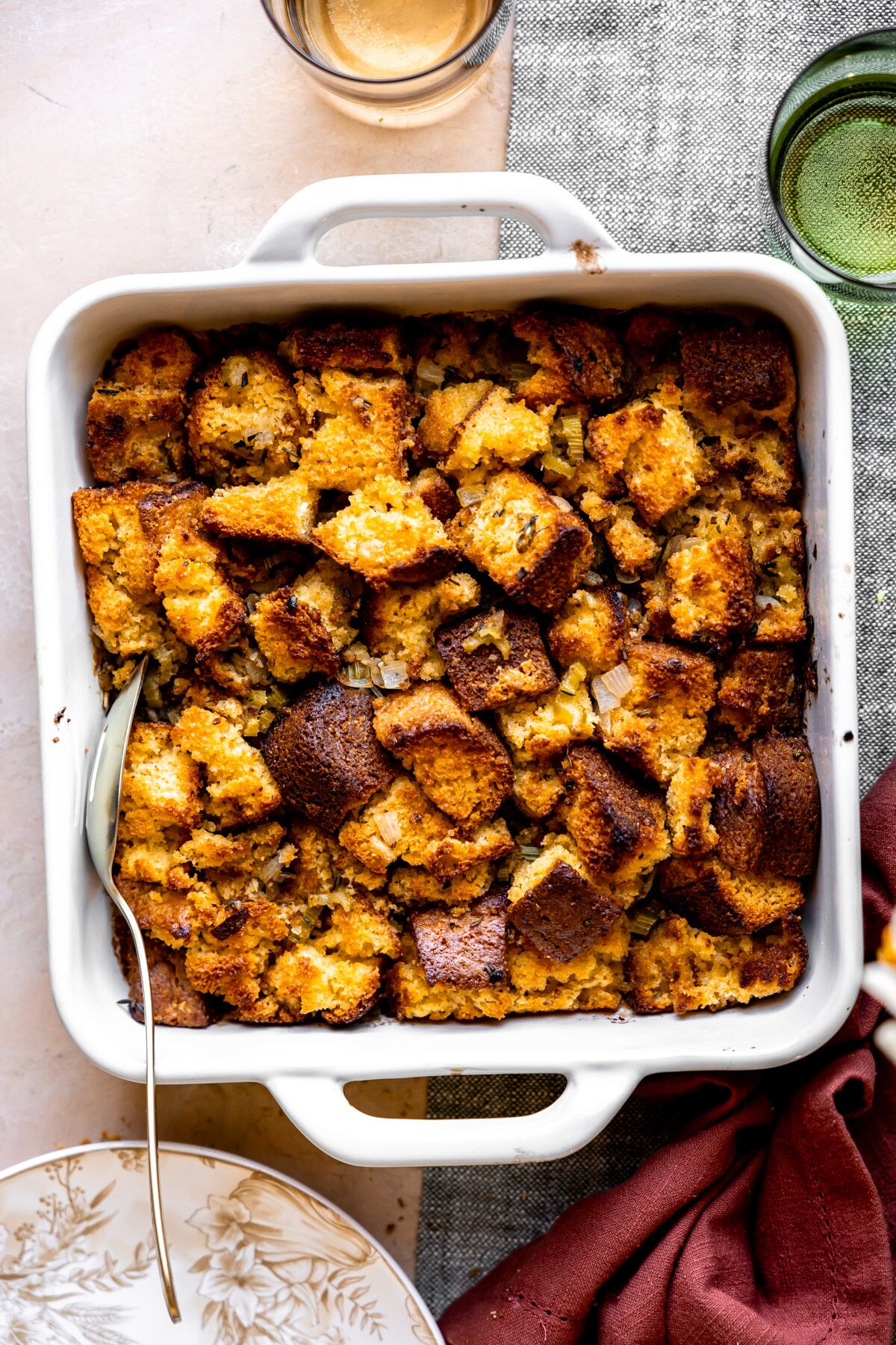 Easy cornbread stuffing in a baking dish on a table.