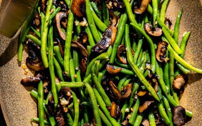 Garlic Mushroom Green Beans on a serving platter with tongs.