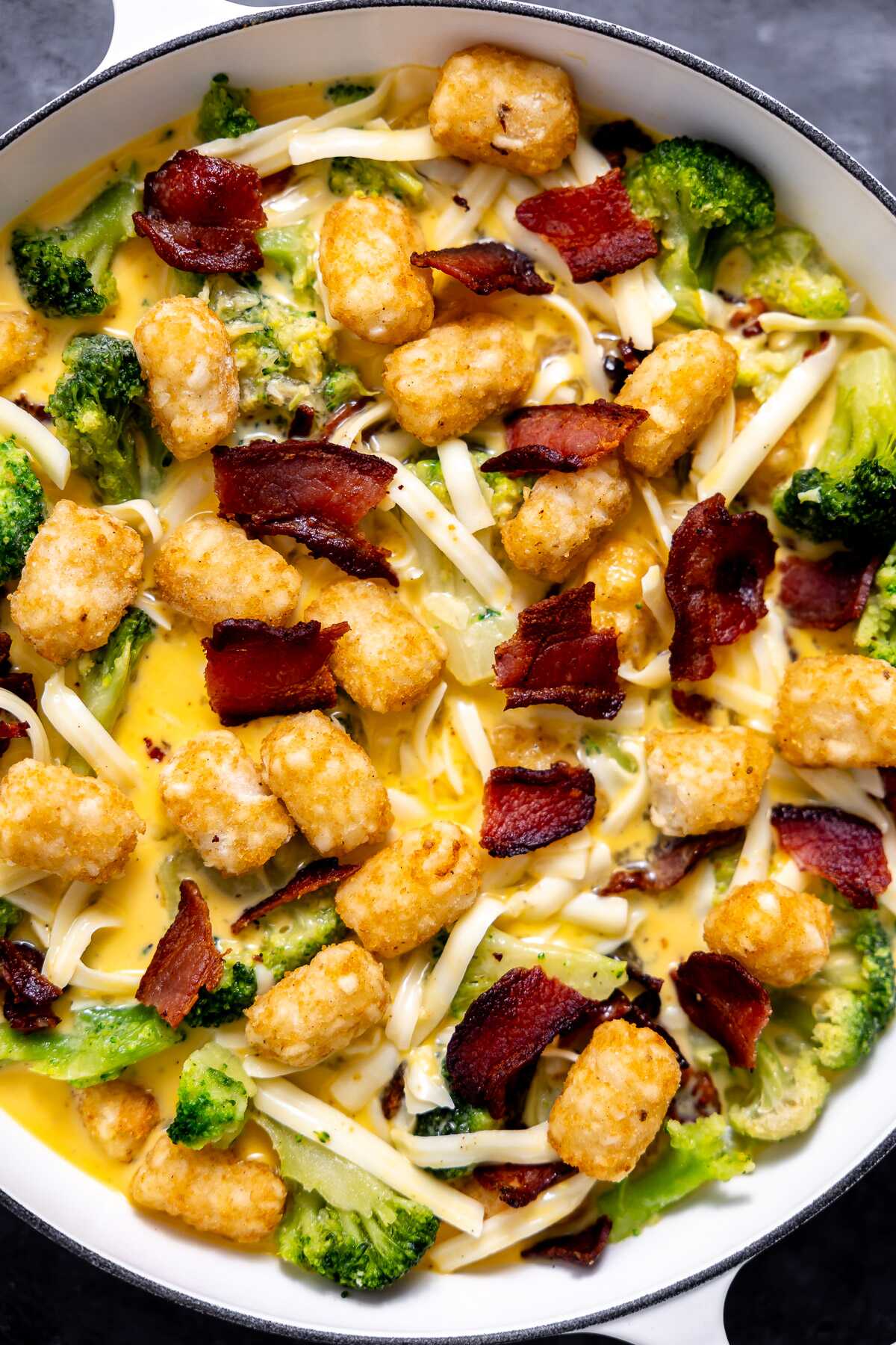 A close-up photo of the bacon broccoli tot breakfast casserole before going into the oven. 
