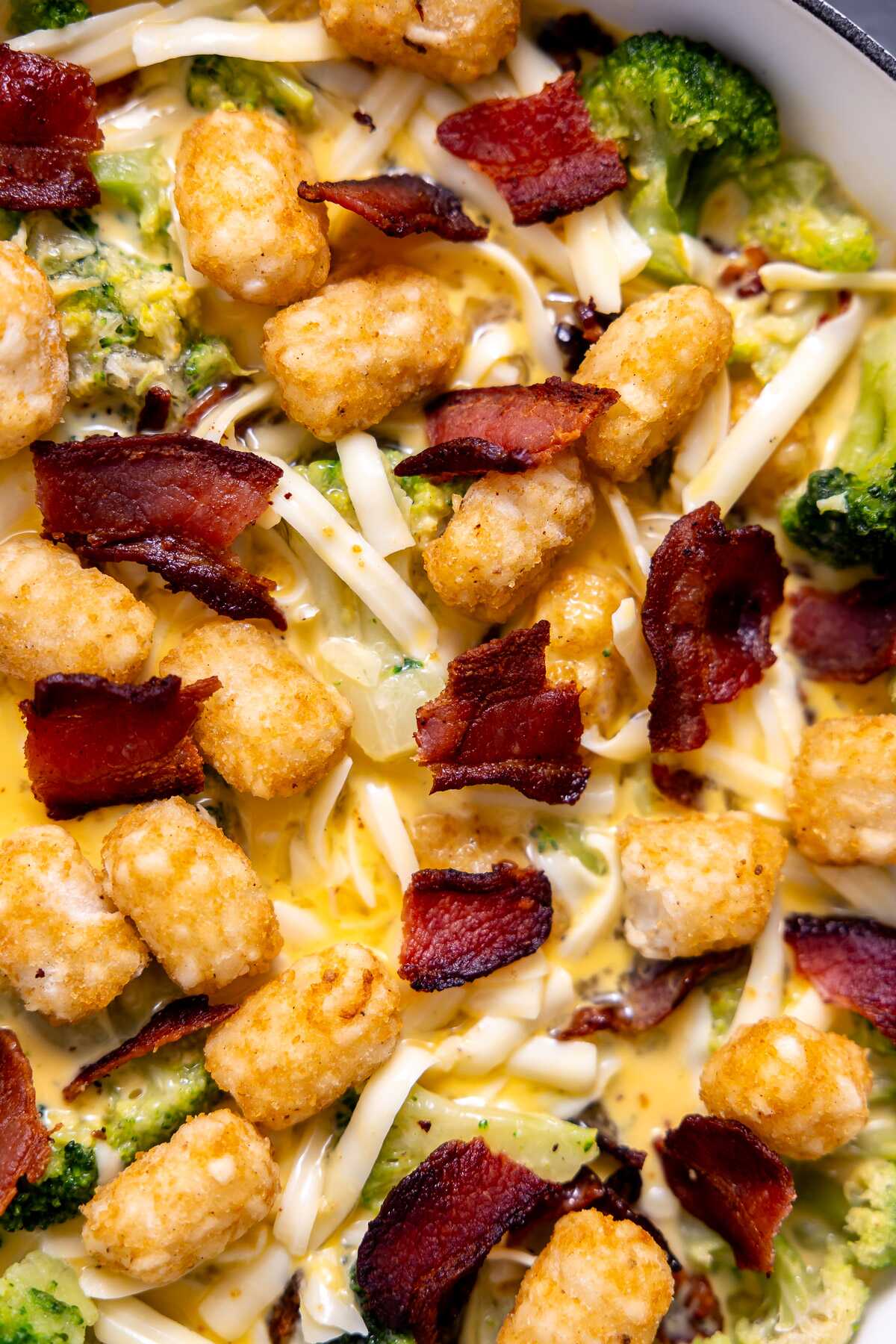A close-up photo of the bacon broccoli tot breakfast casserole before going into the oven.