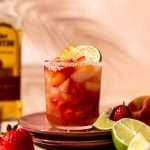 A Strawberry Smash Peach Margarita sitting in direct light waiting to be sipped on!
