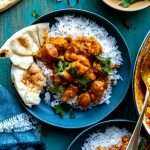 Easy Coconut Chicken Curry served over beds of white rice with naan bread.