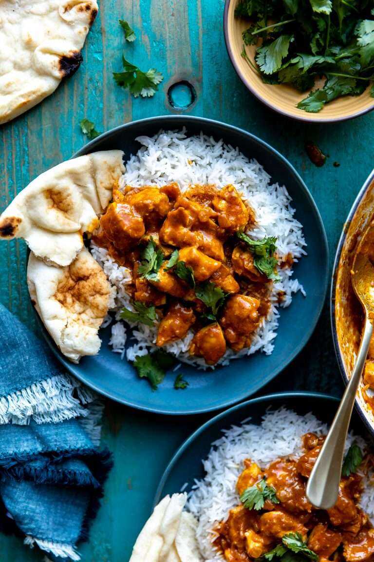 Easy Coconut Chicken Curry served over beds of white rice with naan bread.