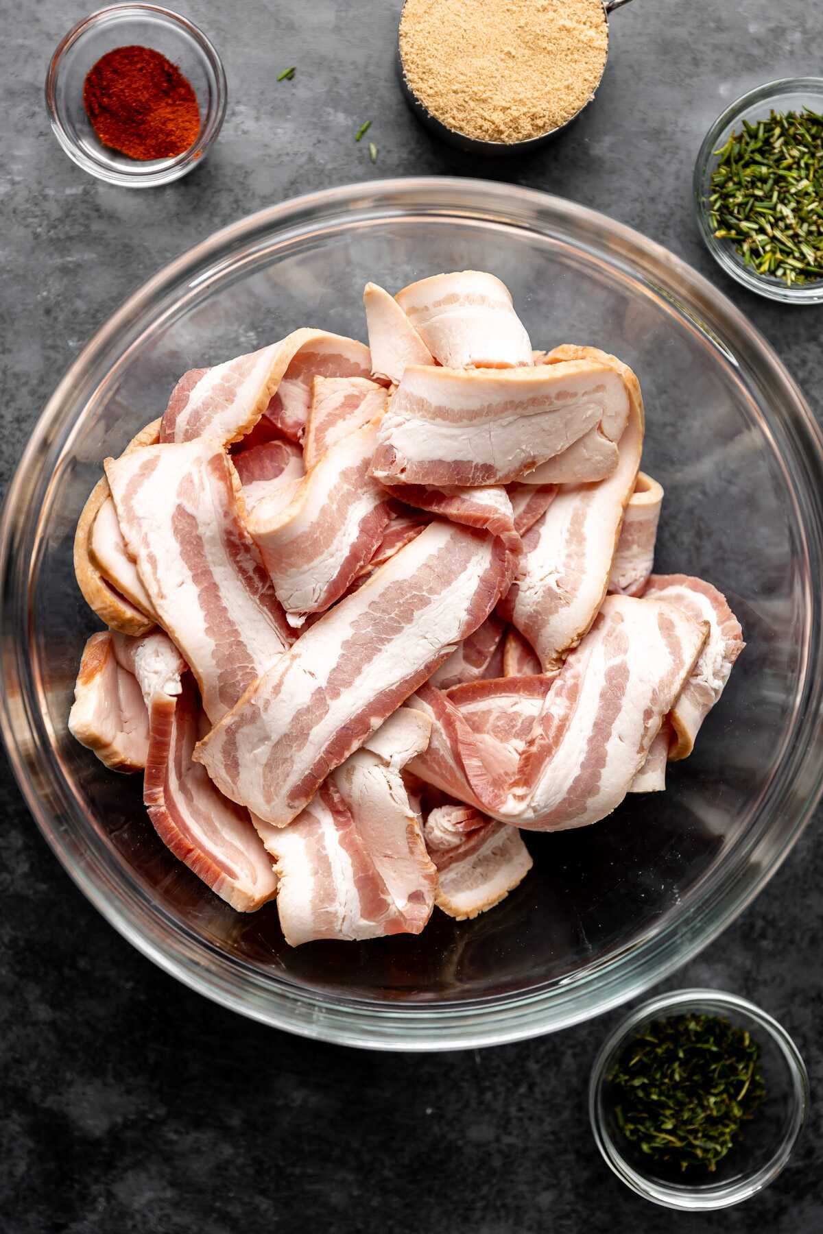 All of the ingredients for herb candied bacon in bowls.
