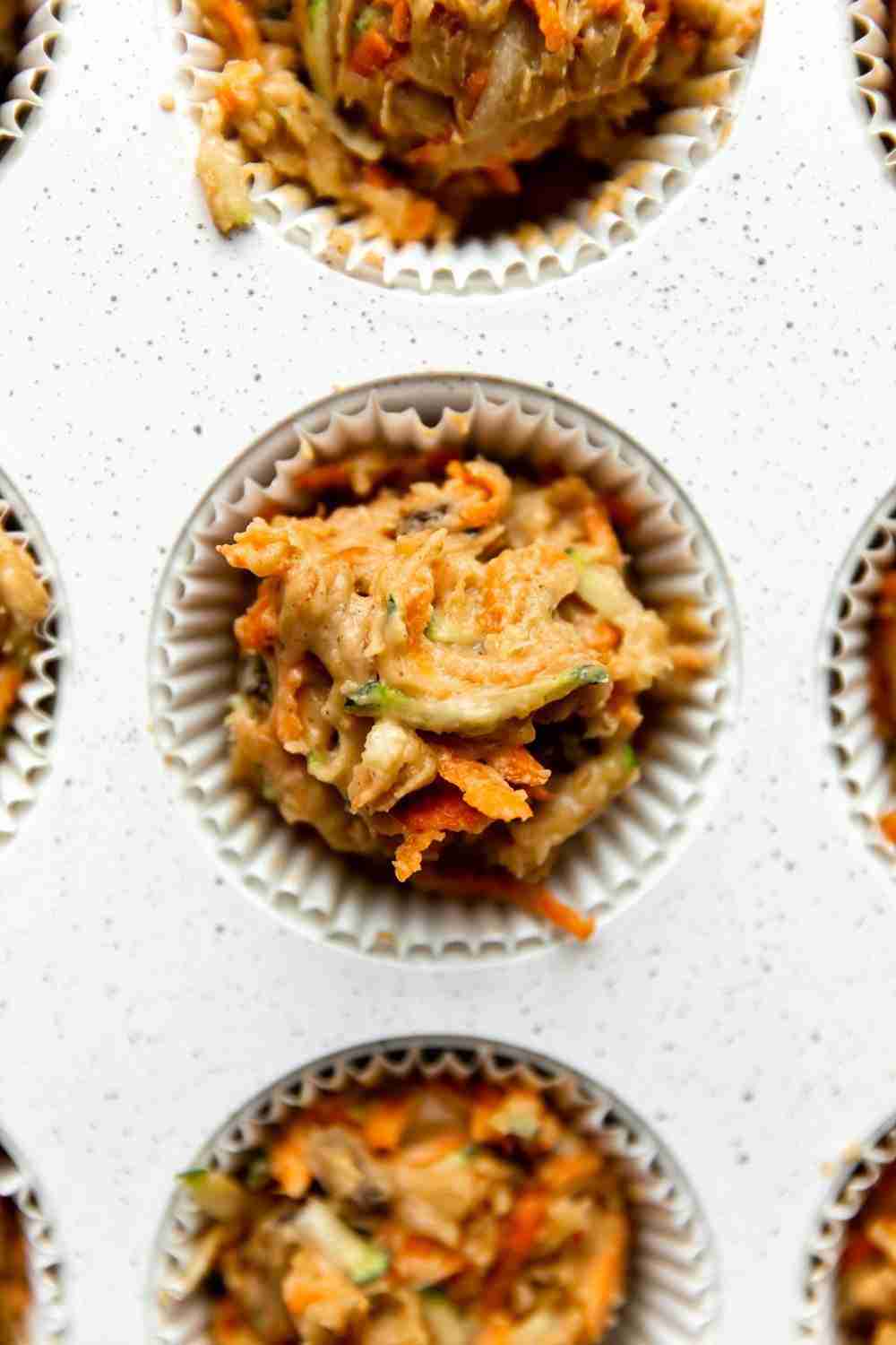 carrot zucchini muffin mix scooped in muffin tins 
