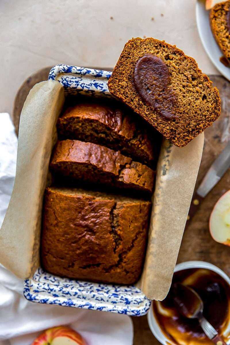 Spiced Apple Butter Bread that has been sliced and smeared with apple butter.