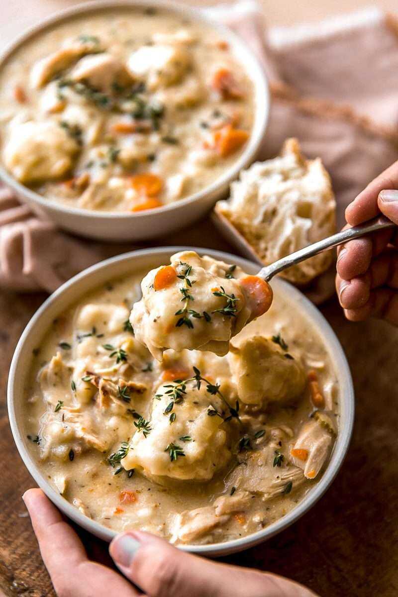 A spoonful of soup being lifted out of the bowl.
