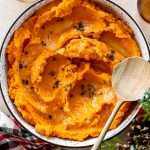 Mashed Sweet Potatoes in a serving platter on the holiday table.