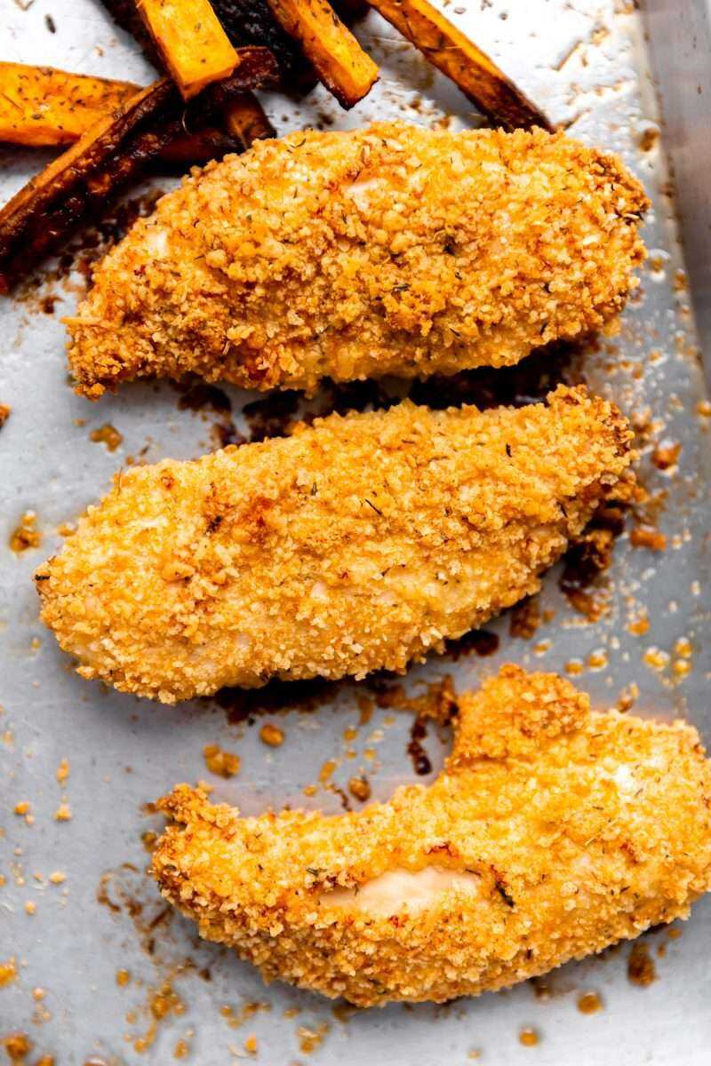 A close-up photo of the crispy chicken fingers out of the oven.