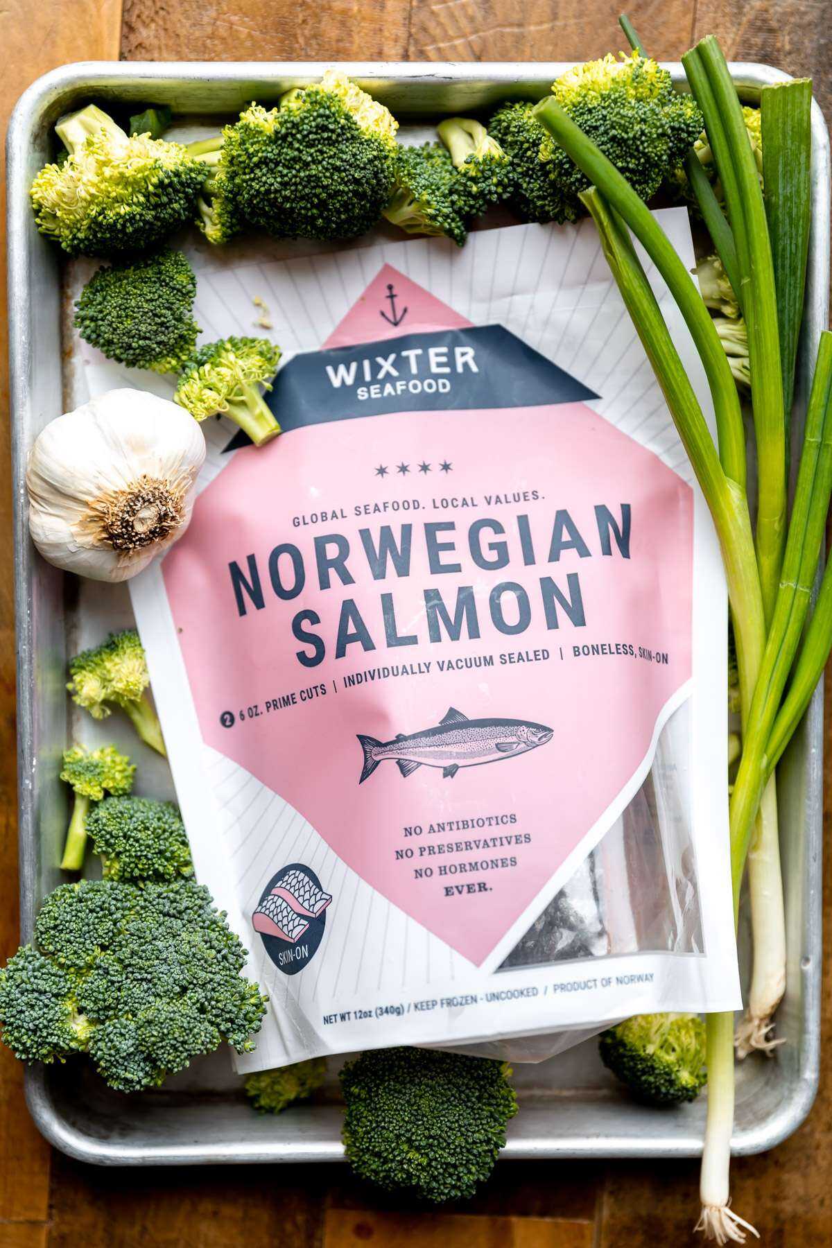 Norwegian Salmon filets in their packaging with the sheet pan ingredients around.
