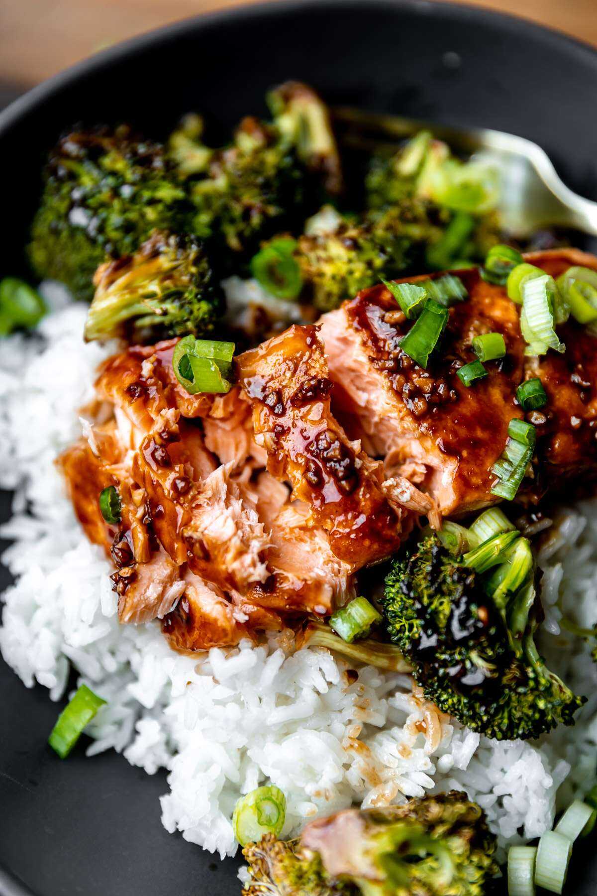 A close-up photo of a roasted salmon filet flaked open.