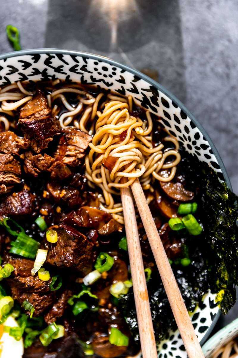 Chopsticks swirled around ramen noodles.