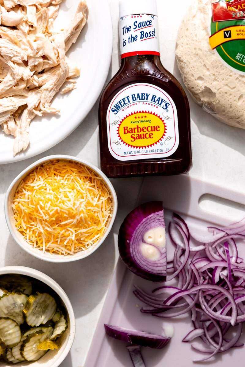 All of the ingredients needed to make bbq chicken pizza.