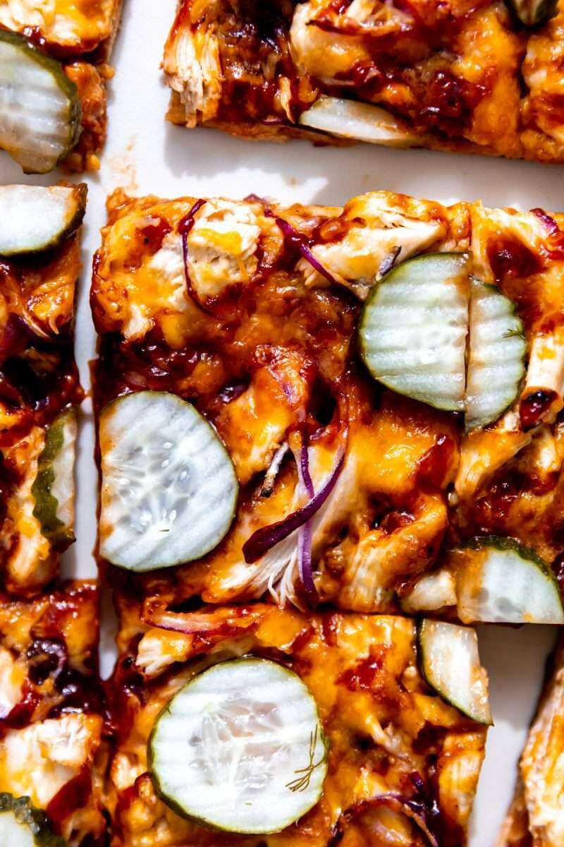 A close-up photo of a slice of bbq chicken pizza.