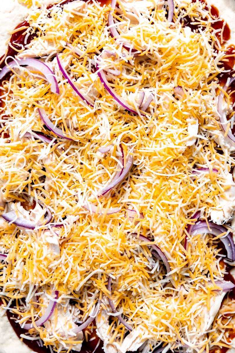Red onions and cheese on a bbq chicken pizza.