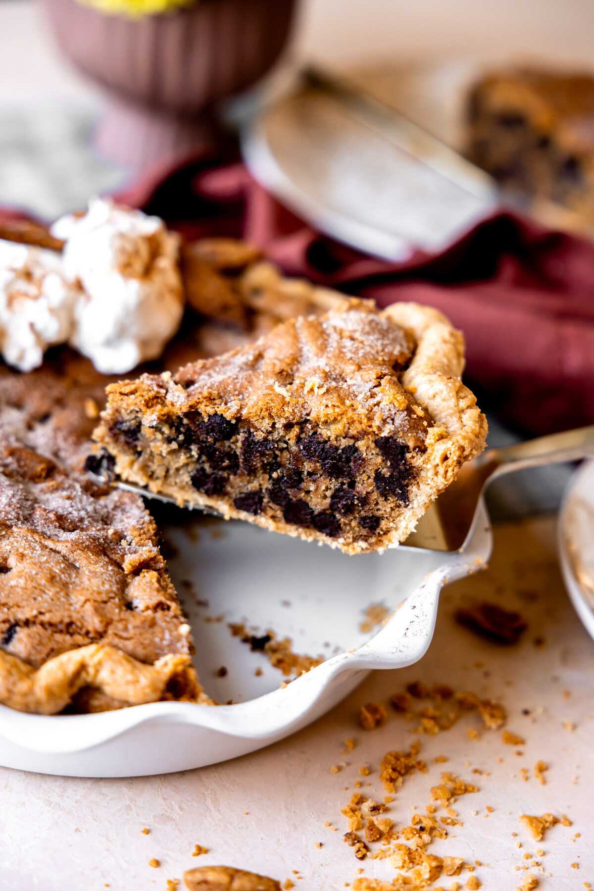 A slice of cinnamon chocolate chip cookie pie being lifted out of the pie plate. 
