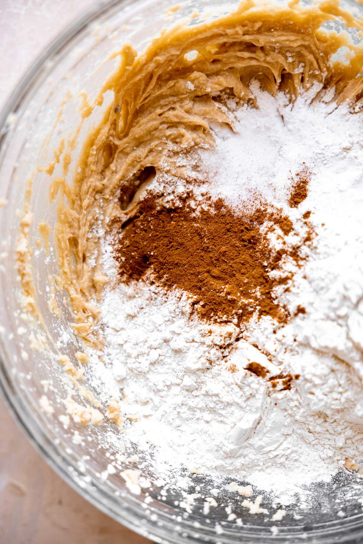 Cinnamon and other dry ingredients being mixed into the cookie dough. 