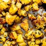 Garlic herb roasted potatoes on a sheet pan.
