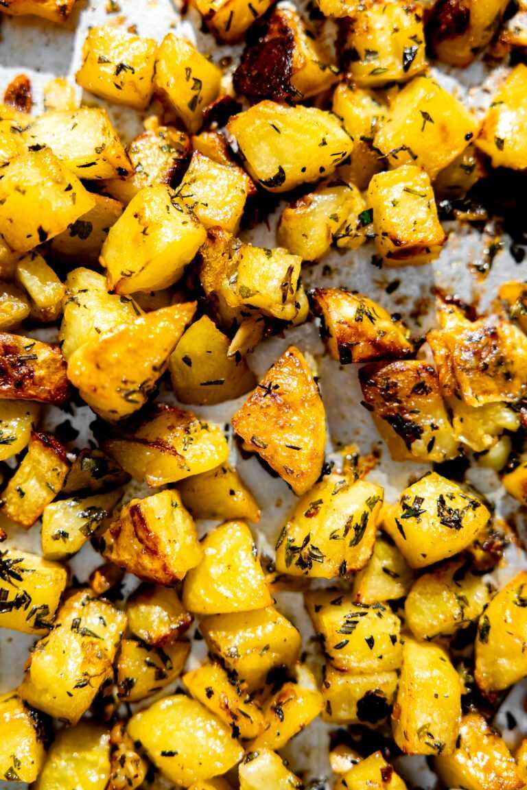 Garlic herb roasted potatoes on a sheet pan.