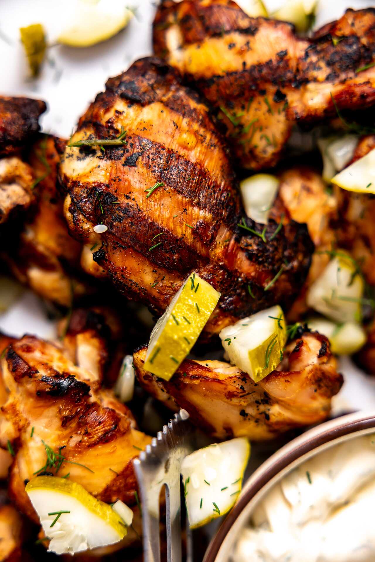 A close-up photo of a grilled chicken thigh.