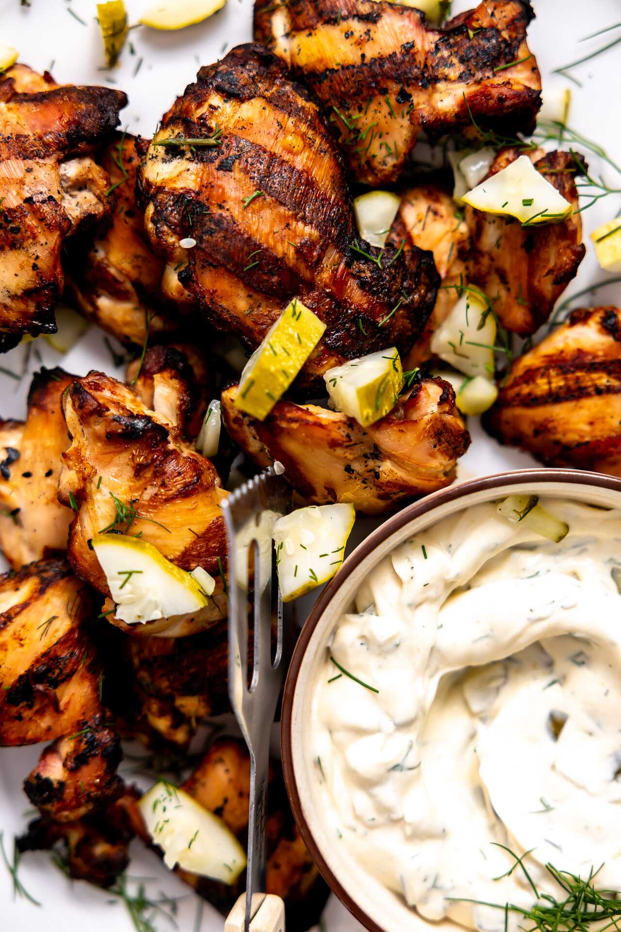 Dill pickle grilled chicken on a platter. 