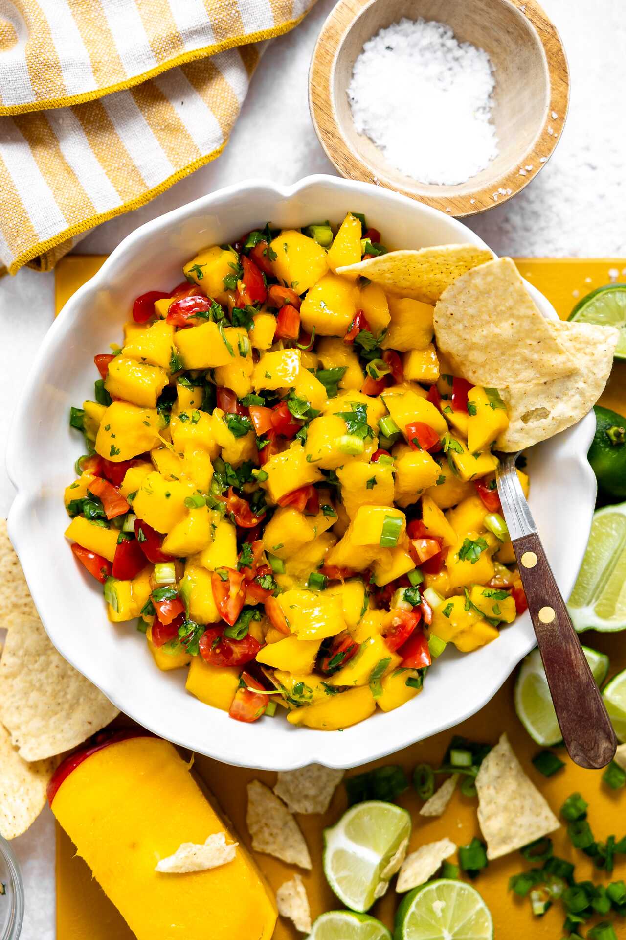 Mango salsa in a serving dish with chips.