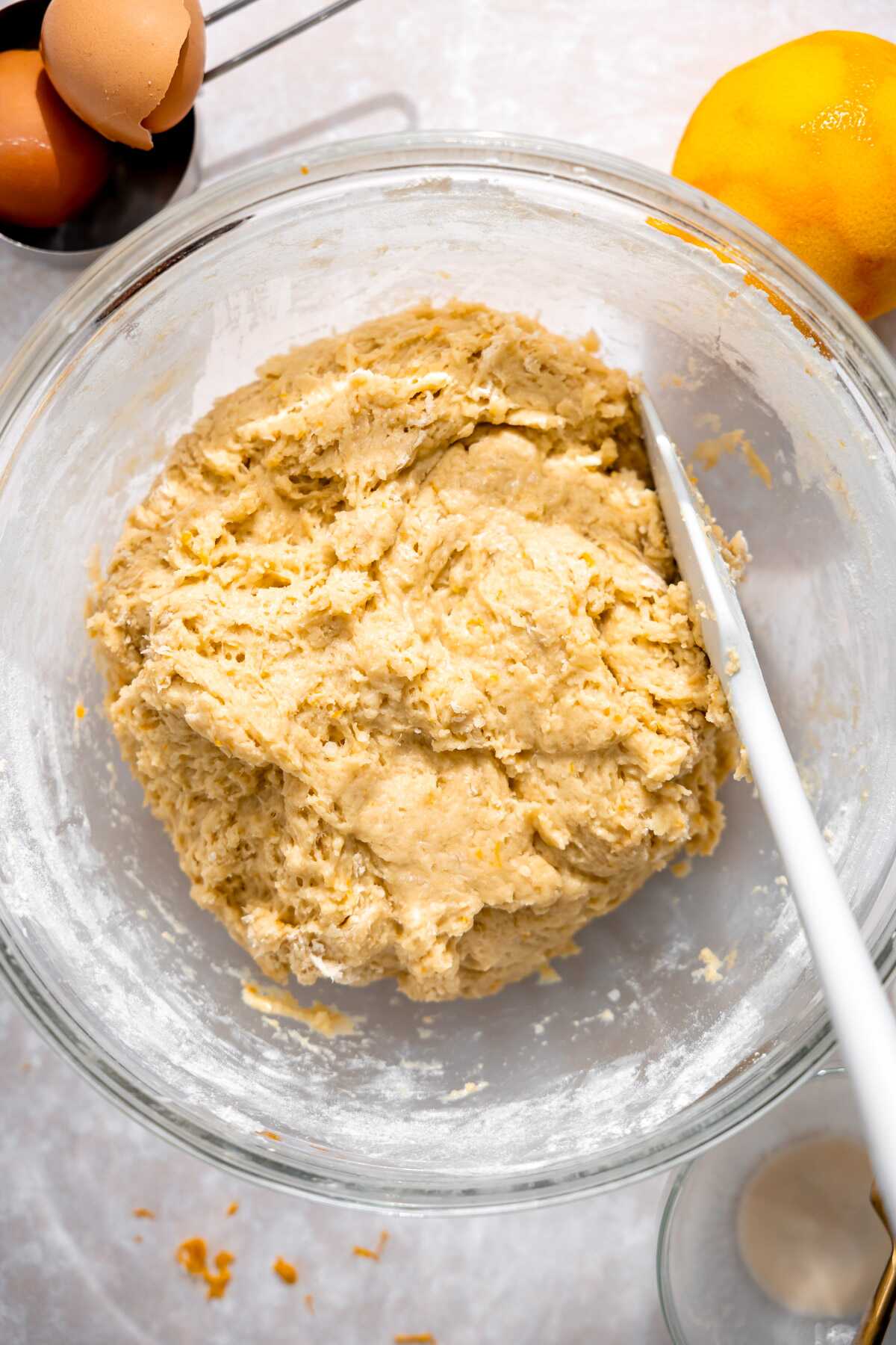 Orange roll dough in a bowl ready to rise.