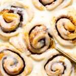 Glazed orange rolls in a baking dish.