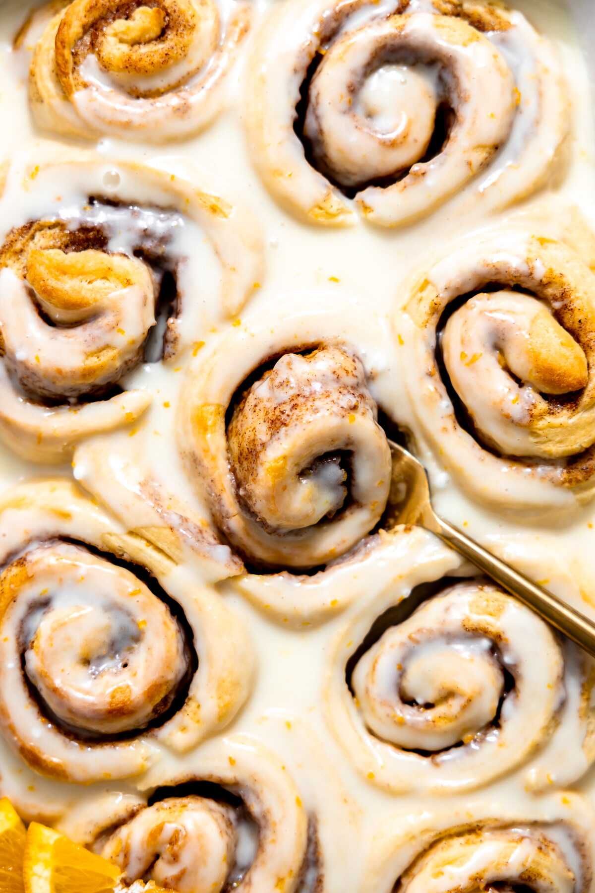 Glazed orange rolls in a baking dish. 