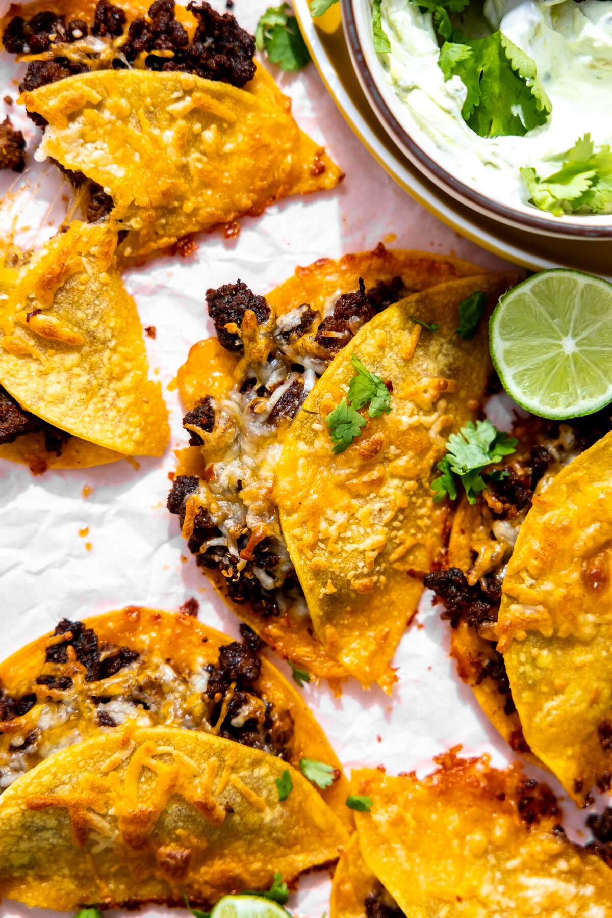 A close-up photo of a cheesy beef sheet pan taco.