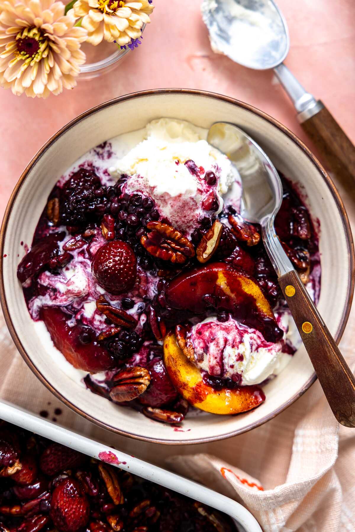 Fruit dump spooned over ice cream in a bowl. 