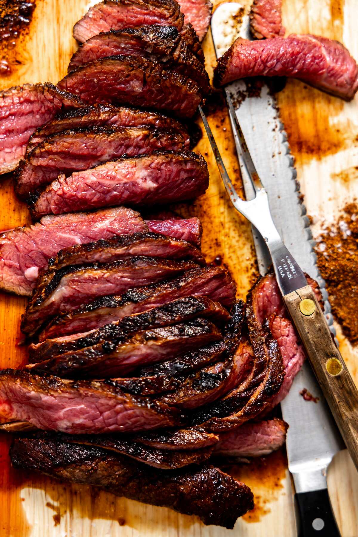 Sliced tri-tip on a wood cutting board. 