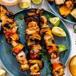 Grilled chicken fajita kabobs served on blue plates.