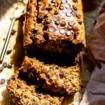 A loaf of gluten free chocolate chip banana bread sliced and ready to serve.