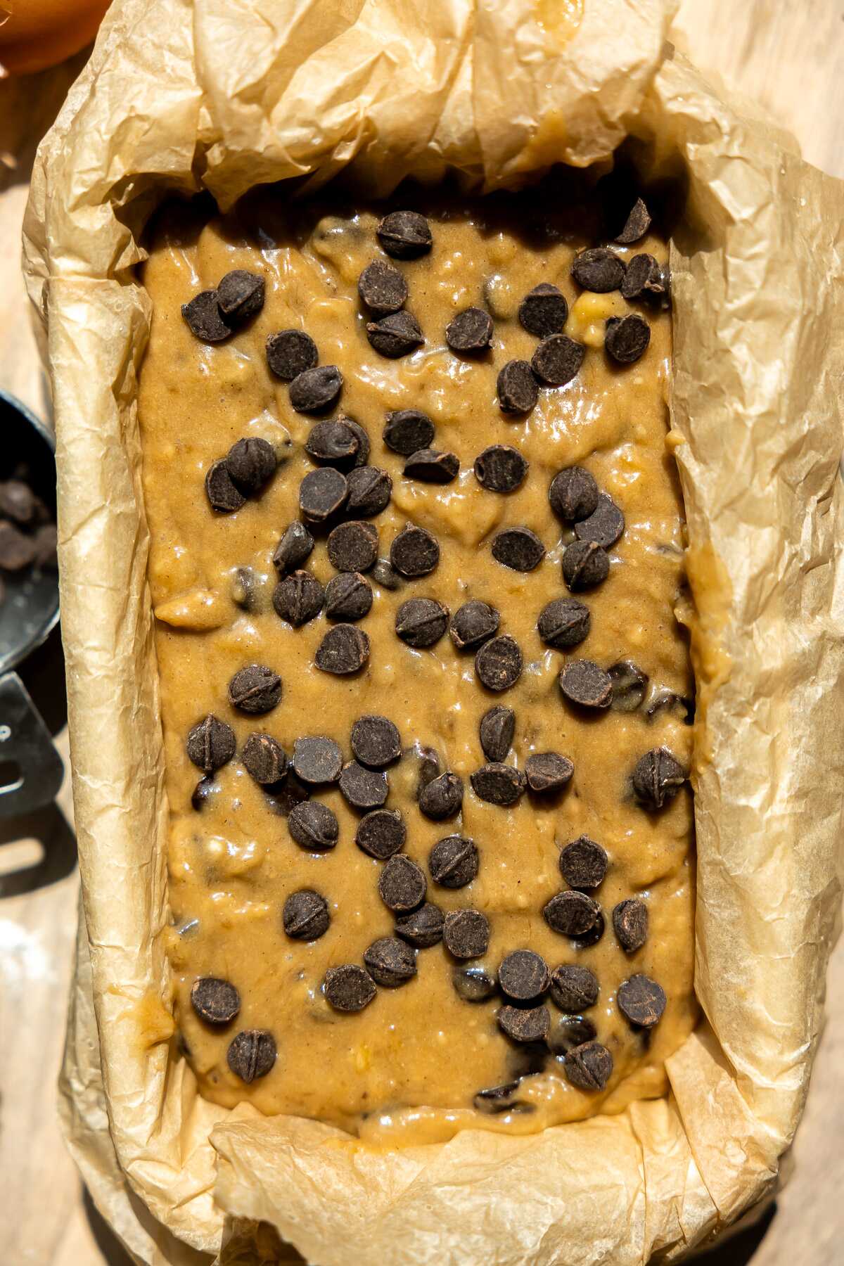 Banana bread topped with chocolate chips ready for the oven. 