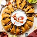 A taco ring with all of the dipping sauces for serving.