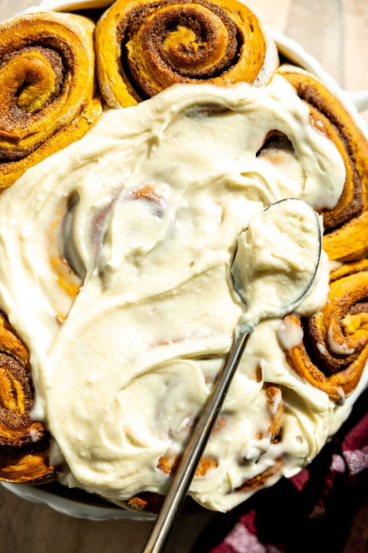 pumpkin cinnamon rolls topped with cream cheese frosting 