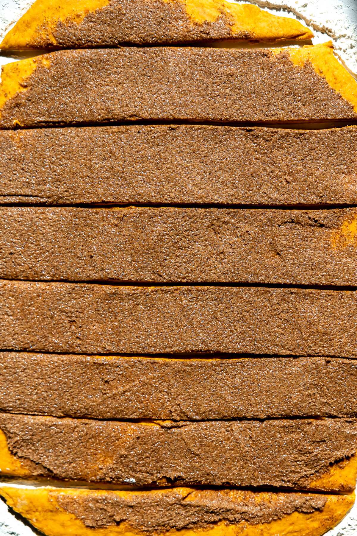 over head shot of pumpin cinnamon rolls sliced into sections. 