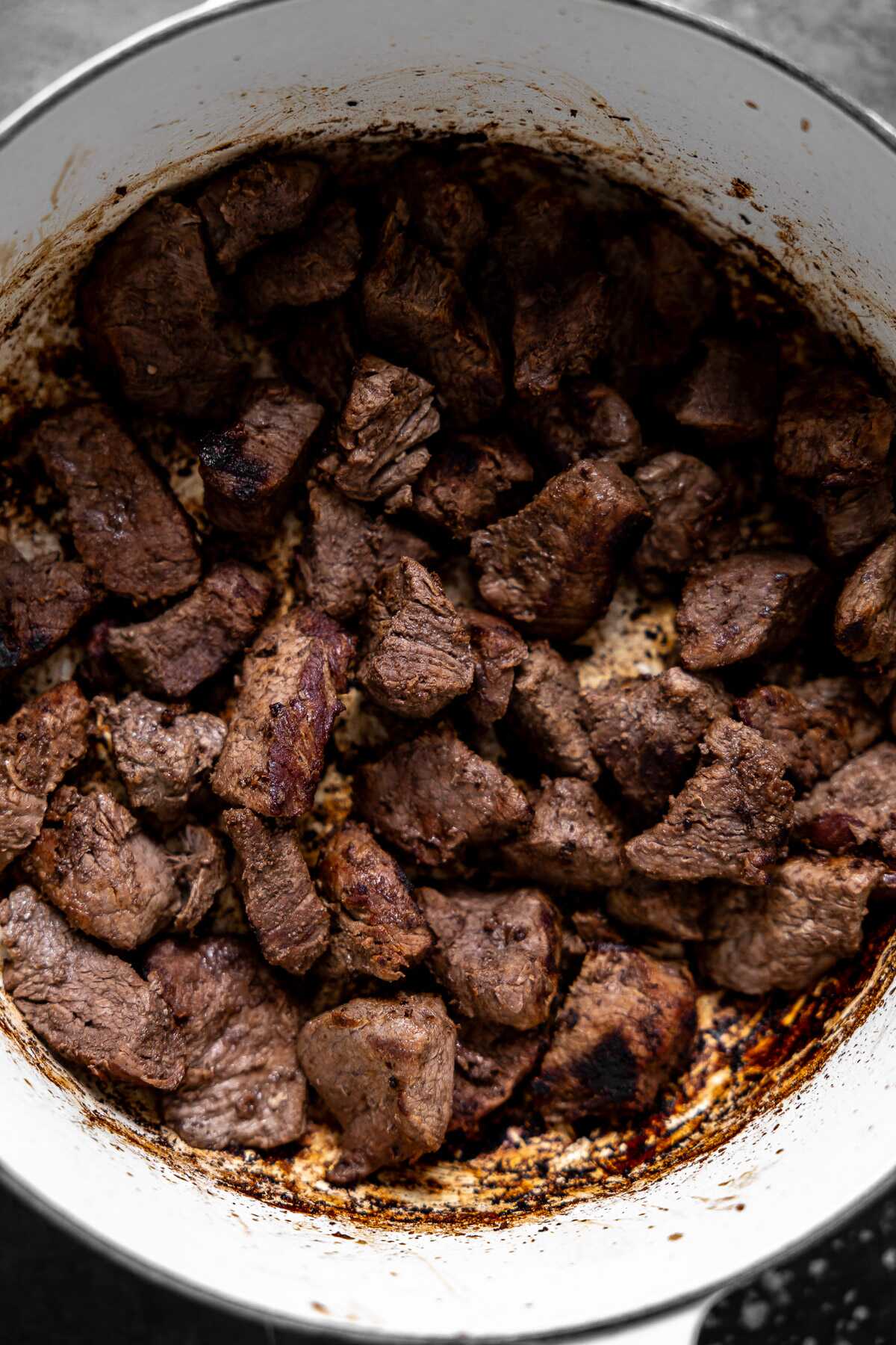 diced tenderloin cooking in a dutch oven 