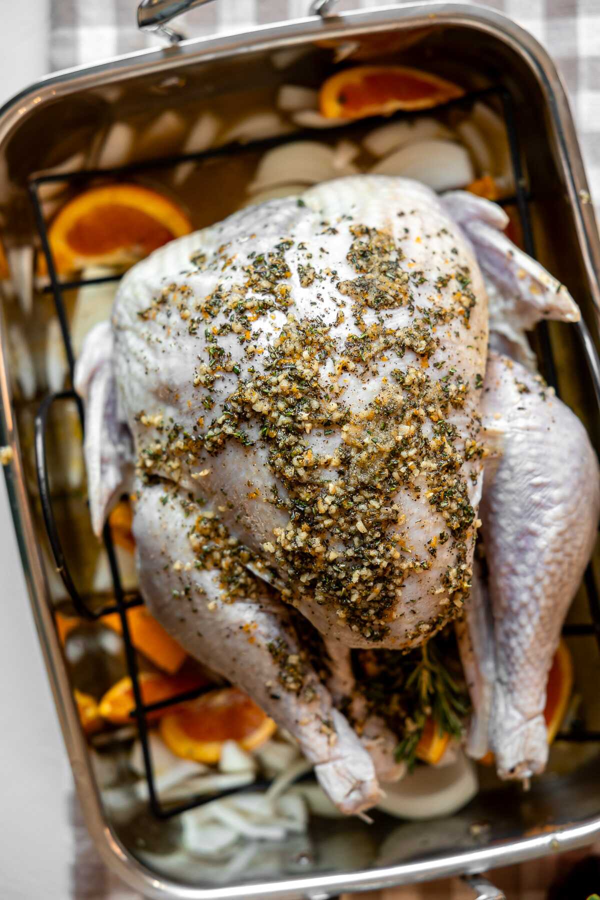 A turkey in a roasting pan prior to going in the oven. 