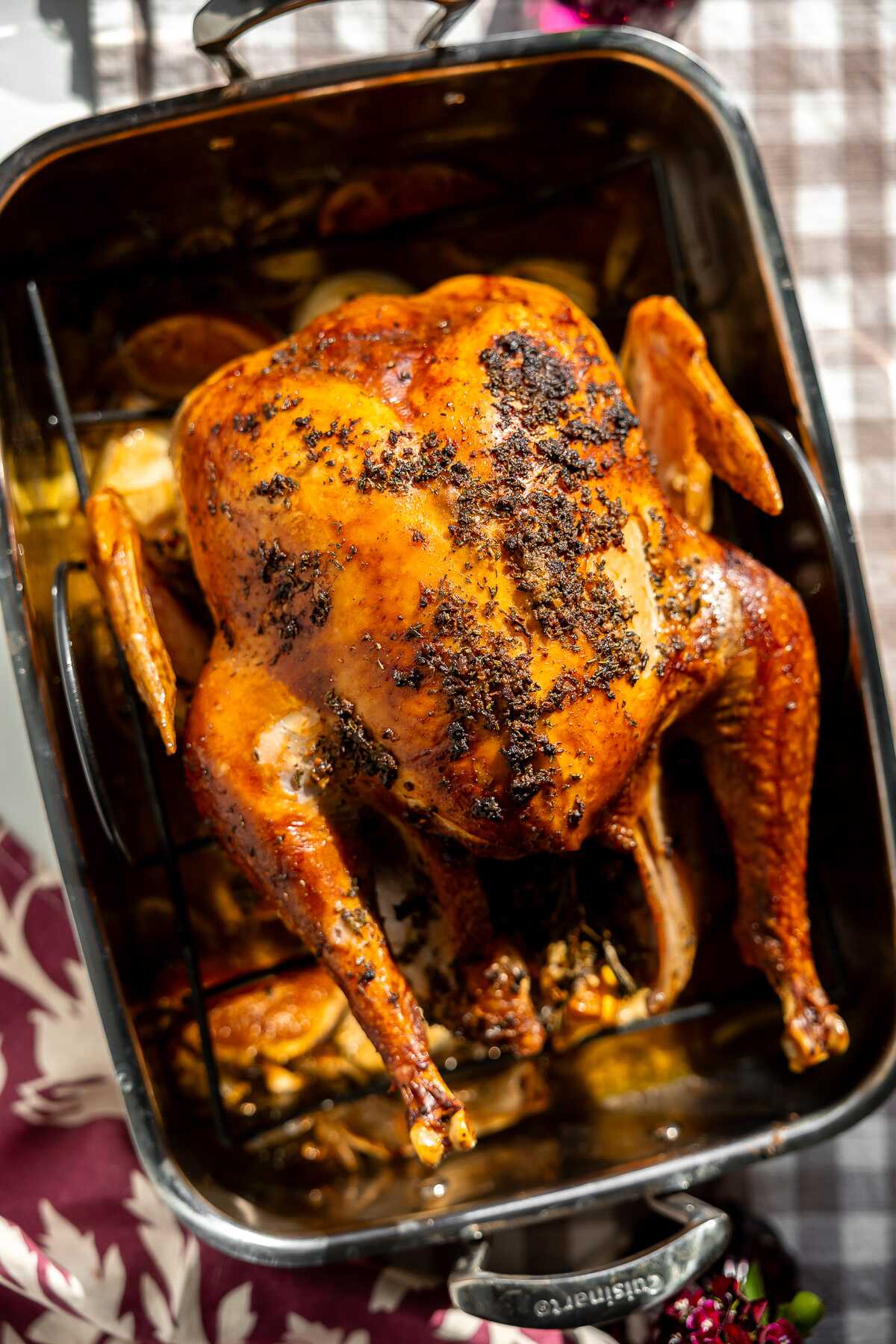 A roasted Citrus Herb Roasted Turkey in a roasting pan. 