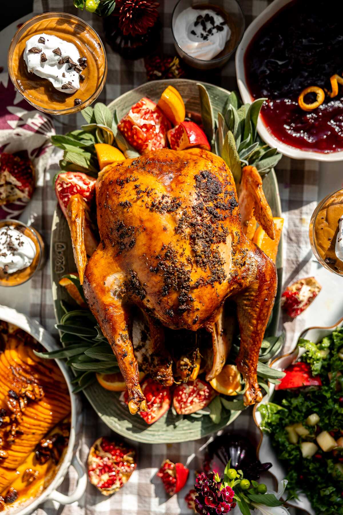 A whole Thanksgiving spread with the turkey in the middle of the table. 