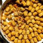 Dairy-free chicken tater tot casserole with a serving taken out of it.