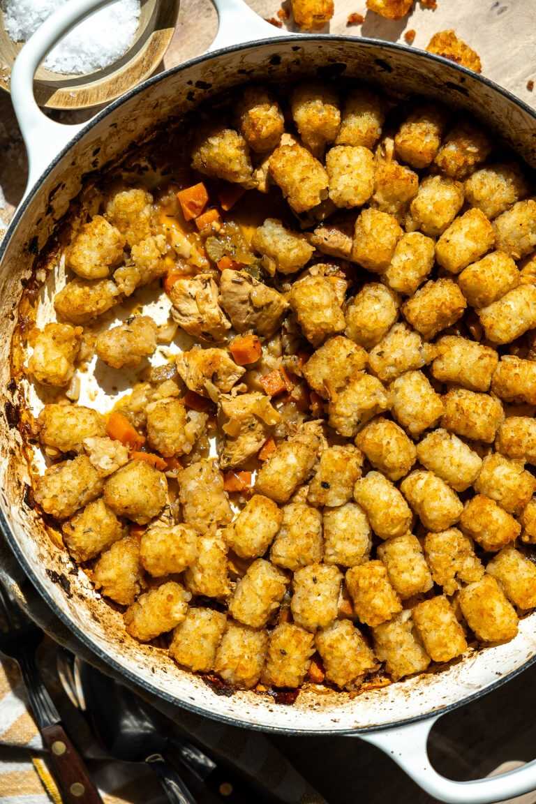 Dairy-free chicken tater tot casserole with a serving taken out of it.