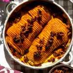 Honey Pecan Hassleback Butternut Squash in a roasting pan on the table.