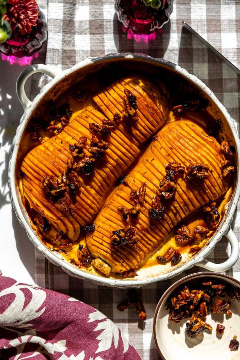 Honey Pecan Hassleback Butternut Squash in a roasting pan on the table.