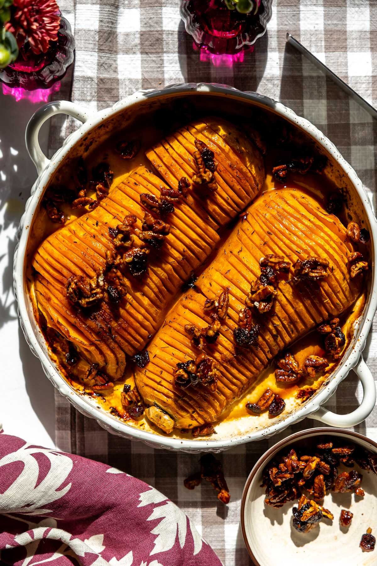 Honey Pecan Hassleback Butternut Squash in a roasting pan on the table.