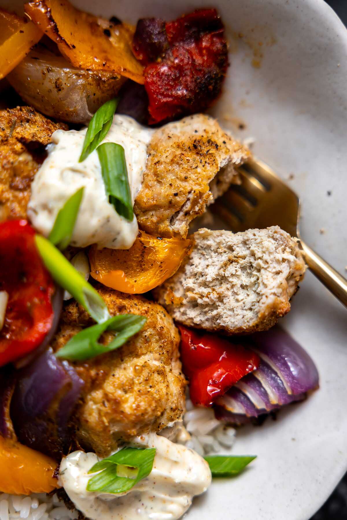 A cajun chicken meatball that has been cut open.